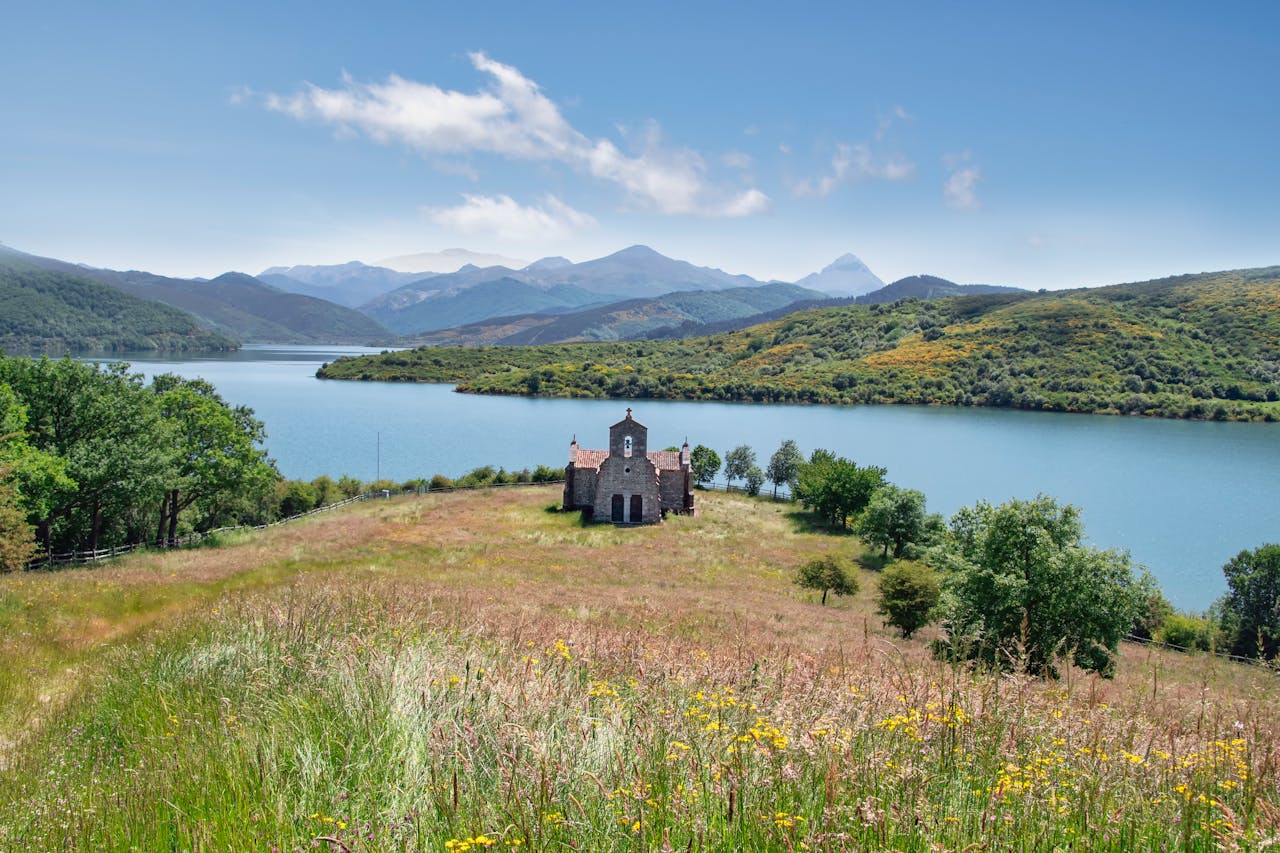 Majestic view of a stone building by a lake in Riaño, Spain.